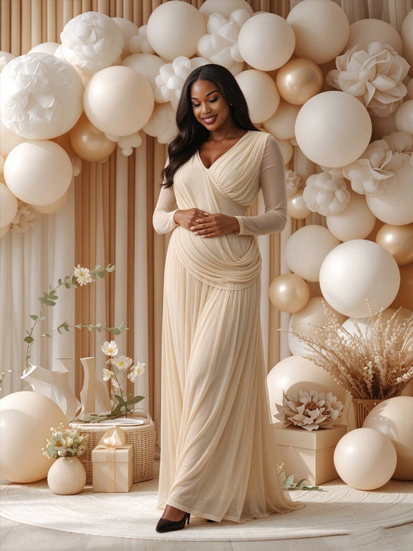 Apricot maternity dress with sheer mesh, pleated details and a backless design, featuring an elegant flowing silhouette for baby showers