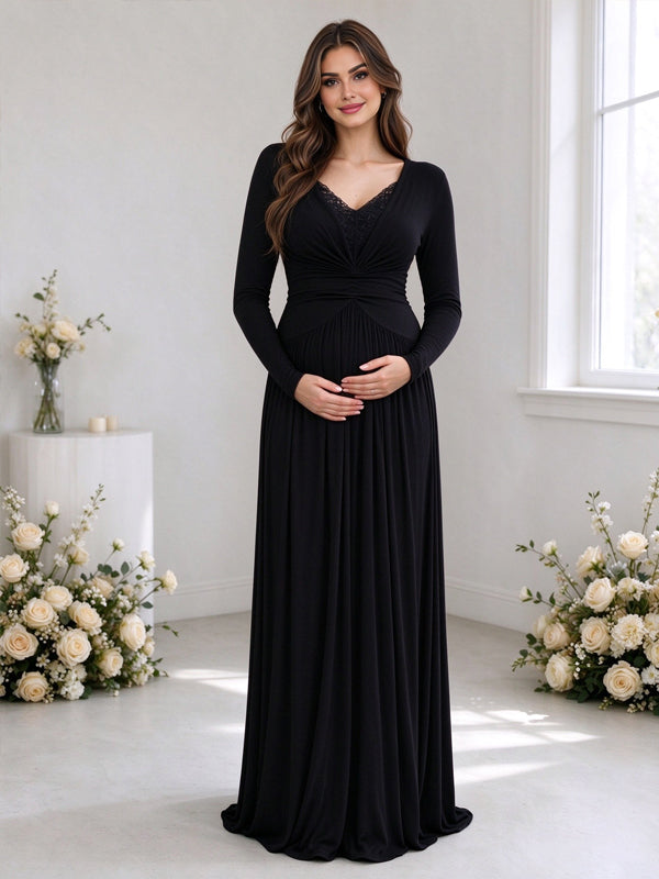 Black maternity maxi dress with lace panels, ruffle accents and pleated details, featuring an elegant flowing silhouette for indoor photoshoots