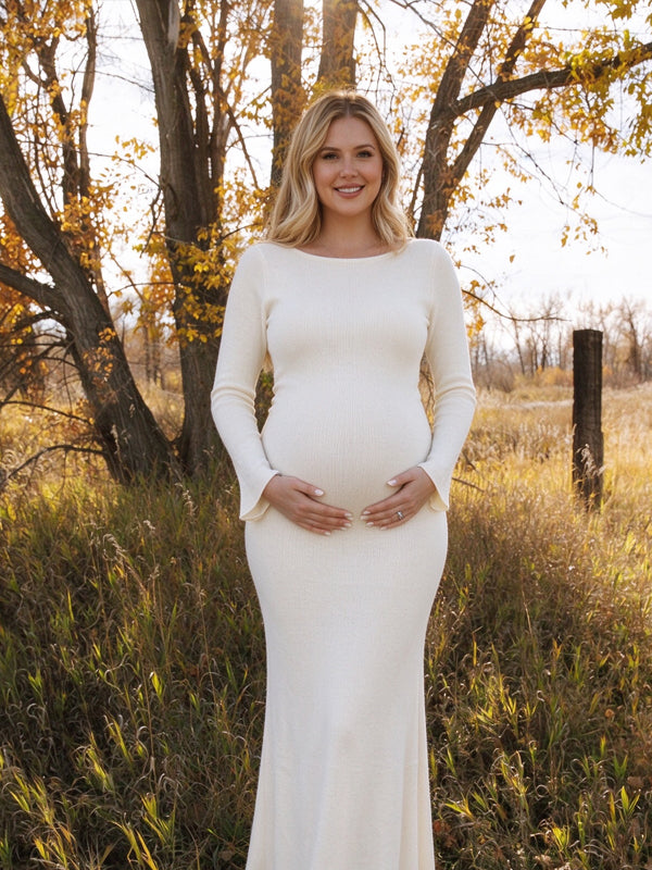 White maternity dress with flared sleeves and a lace-up backless design, featuring an elegant flowing silhouette for photoshoots