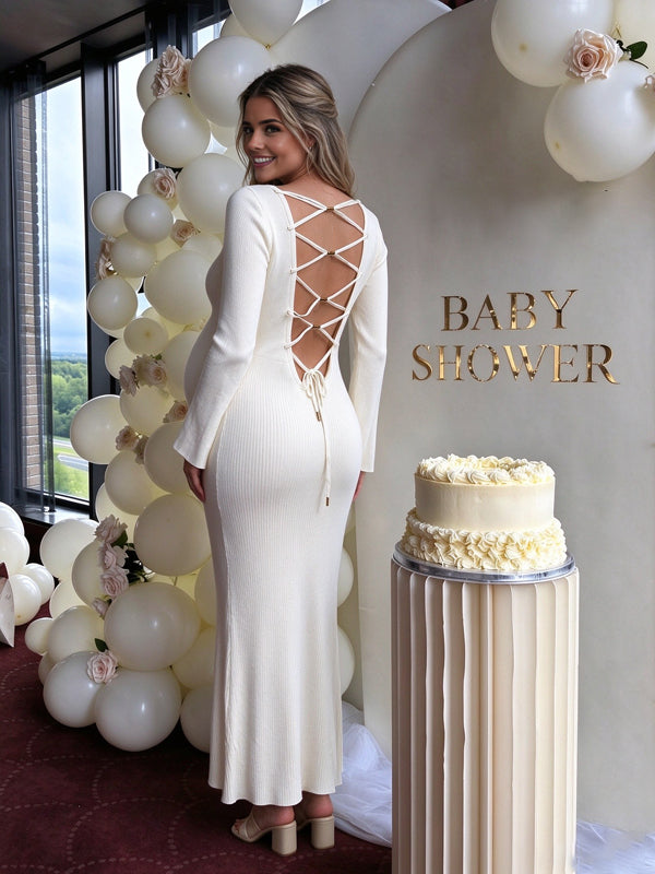White maternity dress with wide flared sleeves and an adjustable lace-up back, flattering silhouette