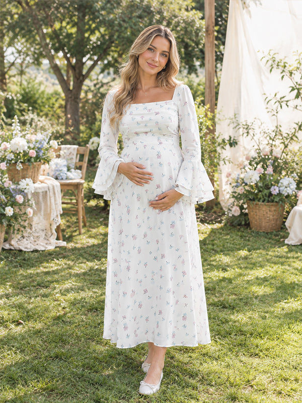 White printed maternity maxi dress with flared sleeves and a flowing silhouette, perfect for photoshoots