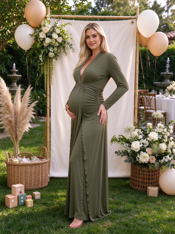 Green maternity dress with a deep V-neck and decorative knot detail, elegant fit with delicate ruffle accents