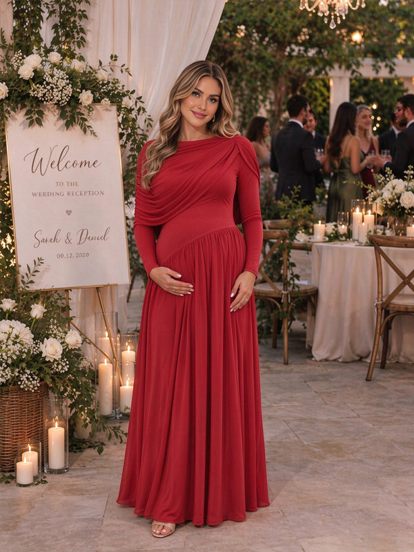 Red maternity maxi dress with a cape-style overlay and ruffled open back, featuring an elegant flowing silhouette for wedding guests