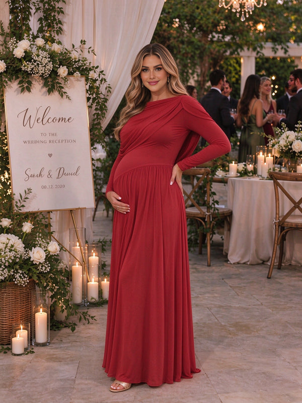 Red maternity maxi dress with a cape overlay and a ruffled backless design