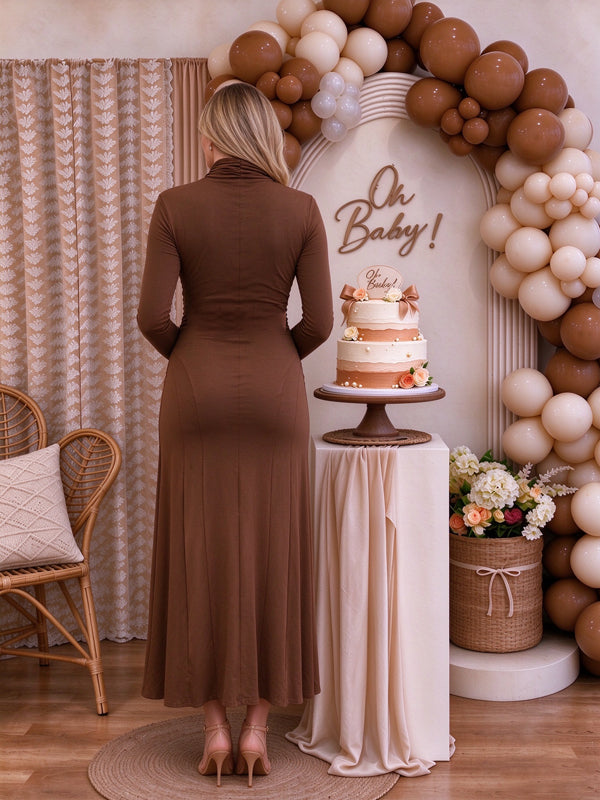 Brown maternity maxi dress with a cross-front bodice and delicate ruffle details, elegant flowing fit