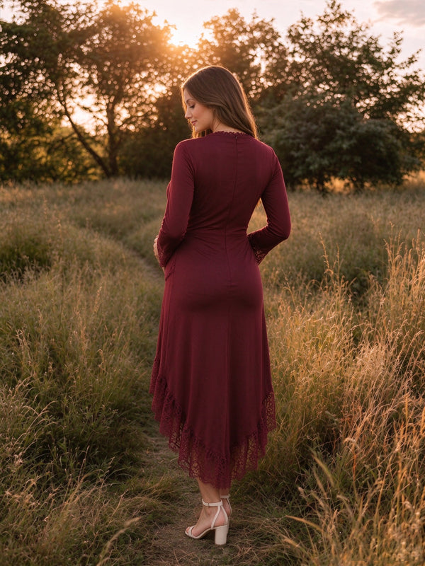 Burgundy V-neck maternity maxi dress with lace panels and an asymmetrical hem, elegant flowing fit