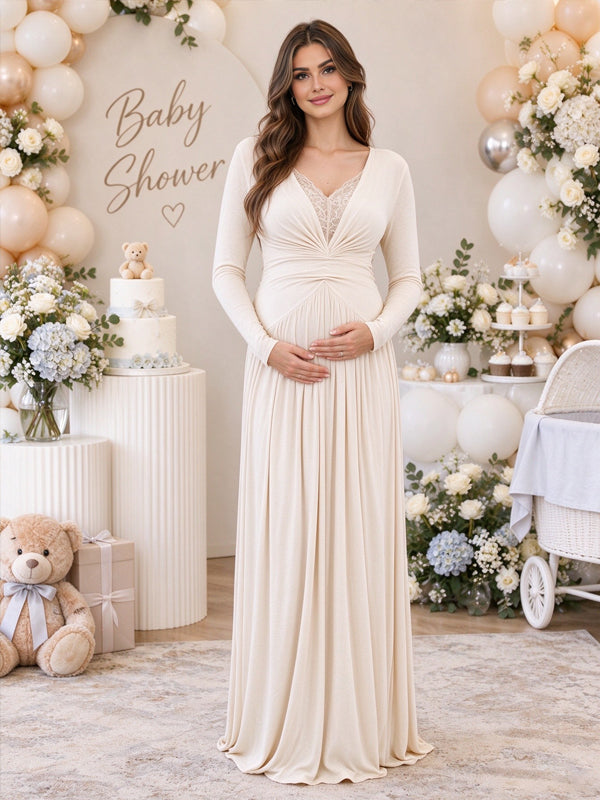 White maternity maxi dress with lace panels, ruffle accents and pleated details, featuring an elegant flowing silhouette for baby showers