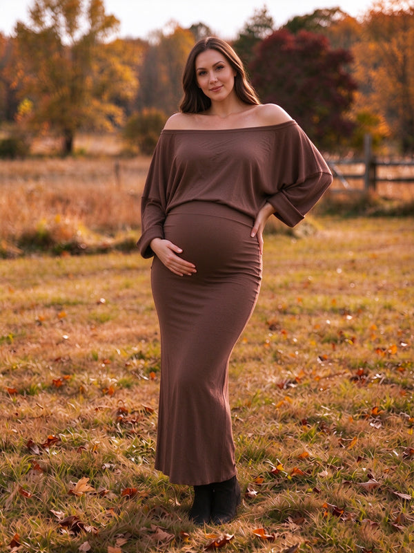 Brown crochet maternity maxi dress with off-the-shoulder and open-back details and a flowing maxi fit, perfect for photoshoots