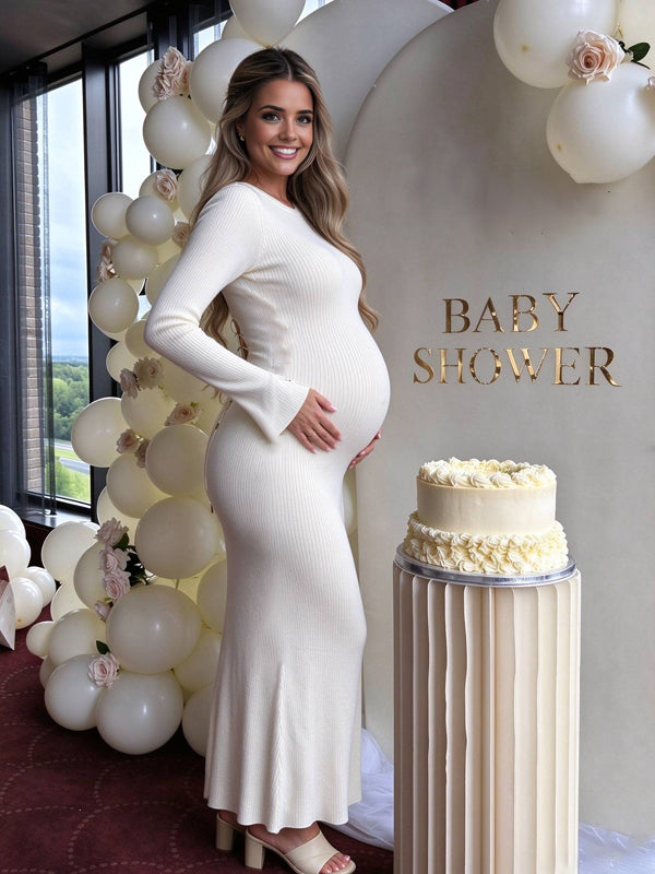 White maternity dress with flared sleeve details and a stylish open back with lace-up ties